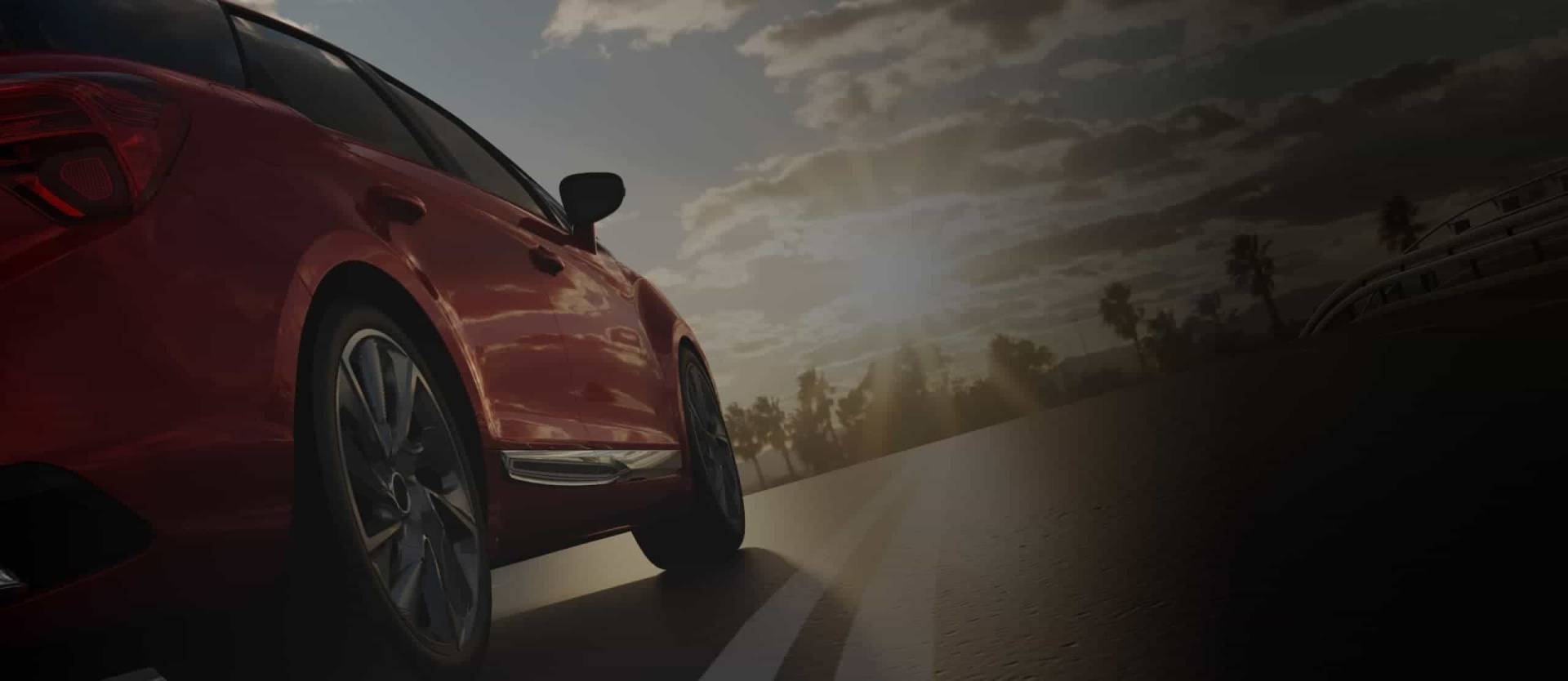 red-car Rotes Auto fährt bei Sonnenuntergang auf einer leeren Straße – Symbol für Mobilität und Freiheit